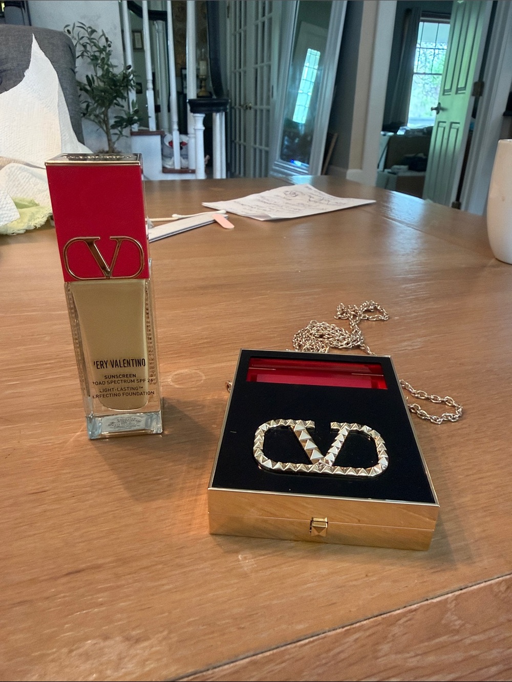 Valentino gold-tone VLogo compact with red accent and chain sold. with suncreen